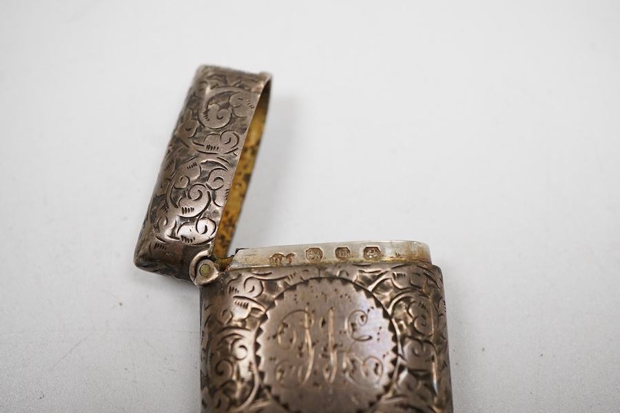 An early Victorian silver rectangular vinaigrette, with engraved chequered decoration, by William Simpson. Birmingham, 1836, 39mm, together with a late Victorian silver vesta case.